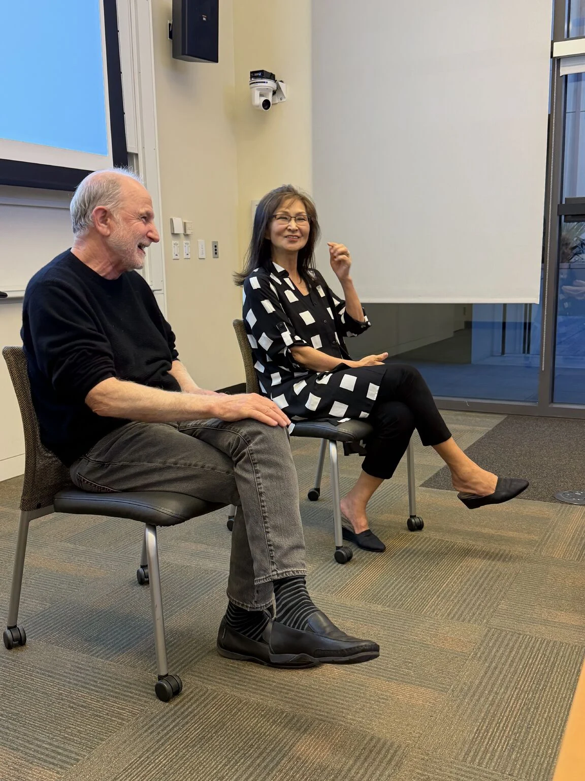 Bill Guttentag and Claudia Fan Munce speaking at RootedIn's 2026 graduation